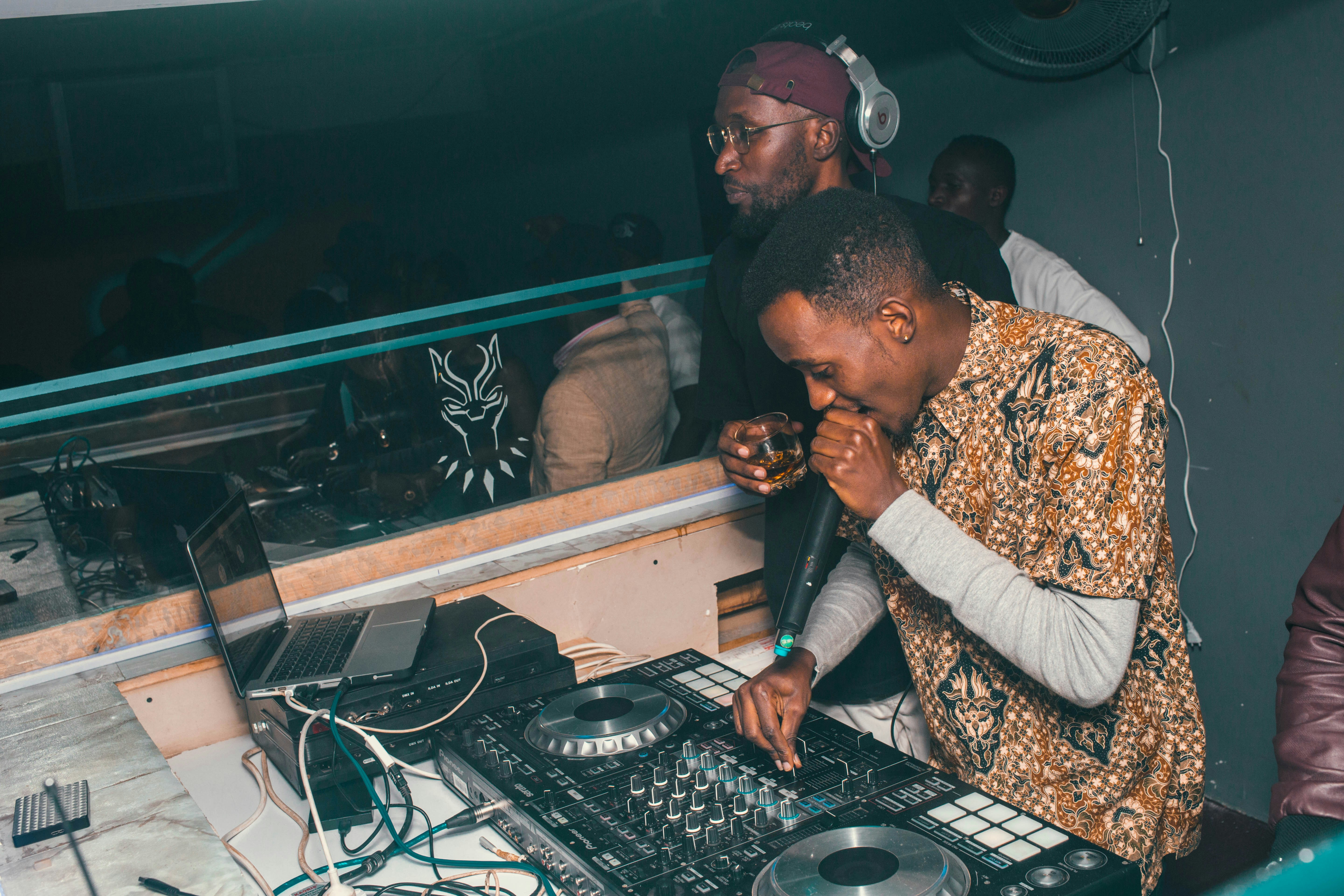Nigerian wedding DJ at a reception setup with turntables and lighting equipment