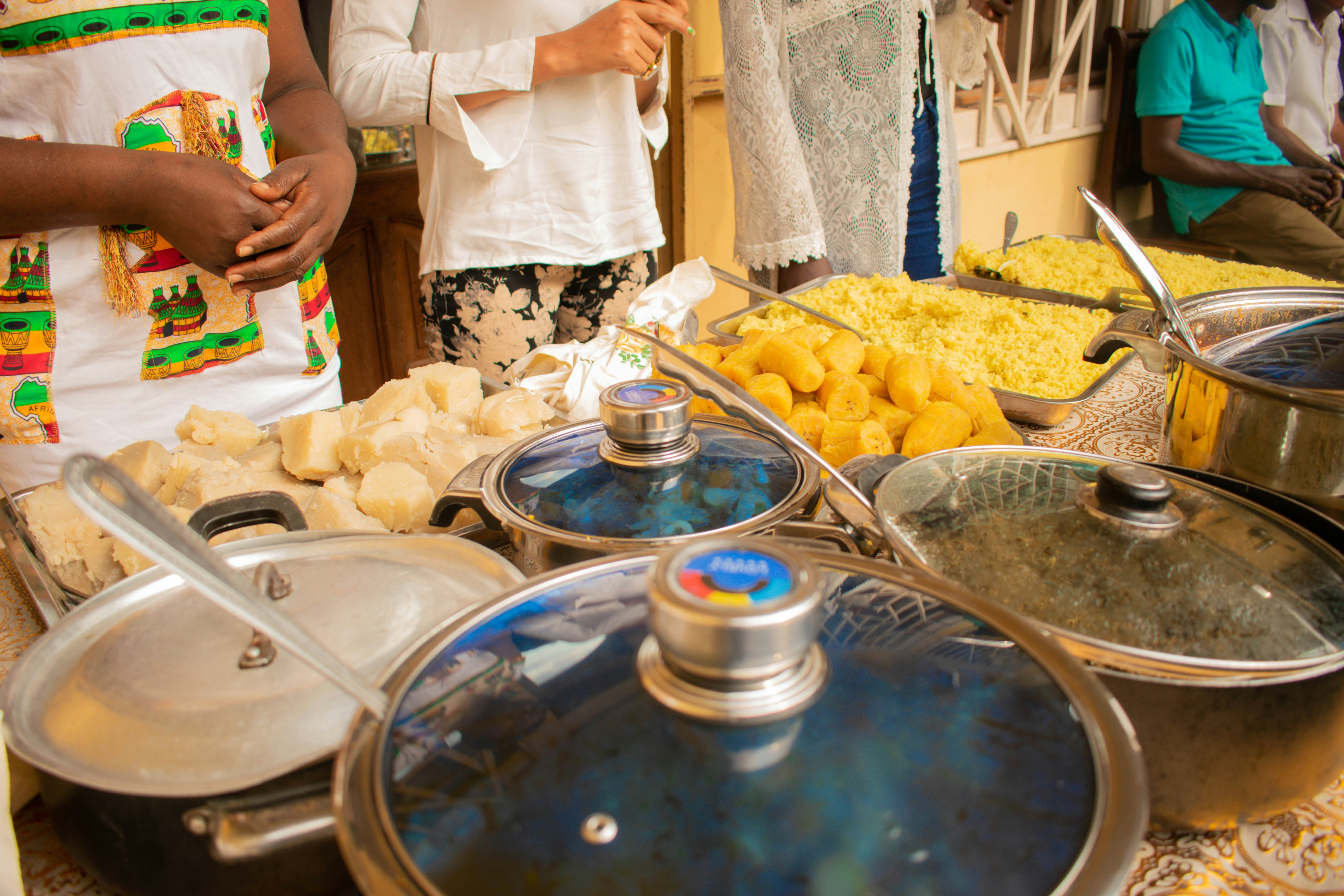 Ghanaian wedding reception food spread with jollof rice, waakye, grilled fish, and other traditional dishes