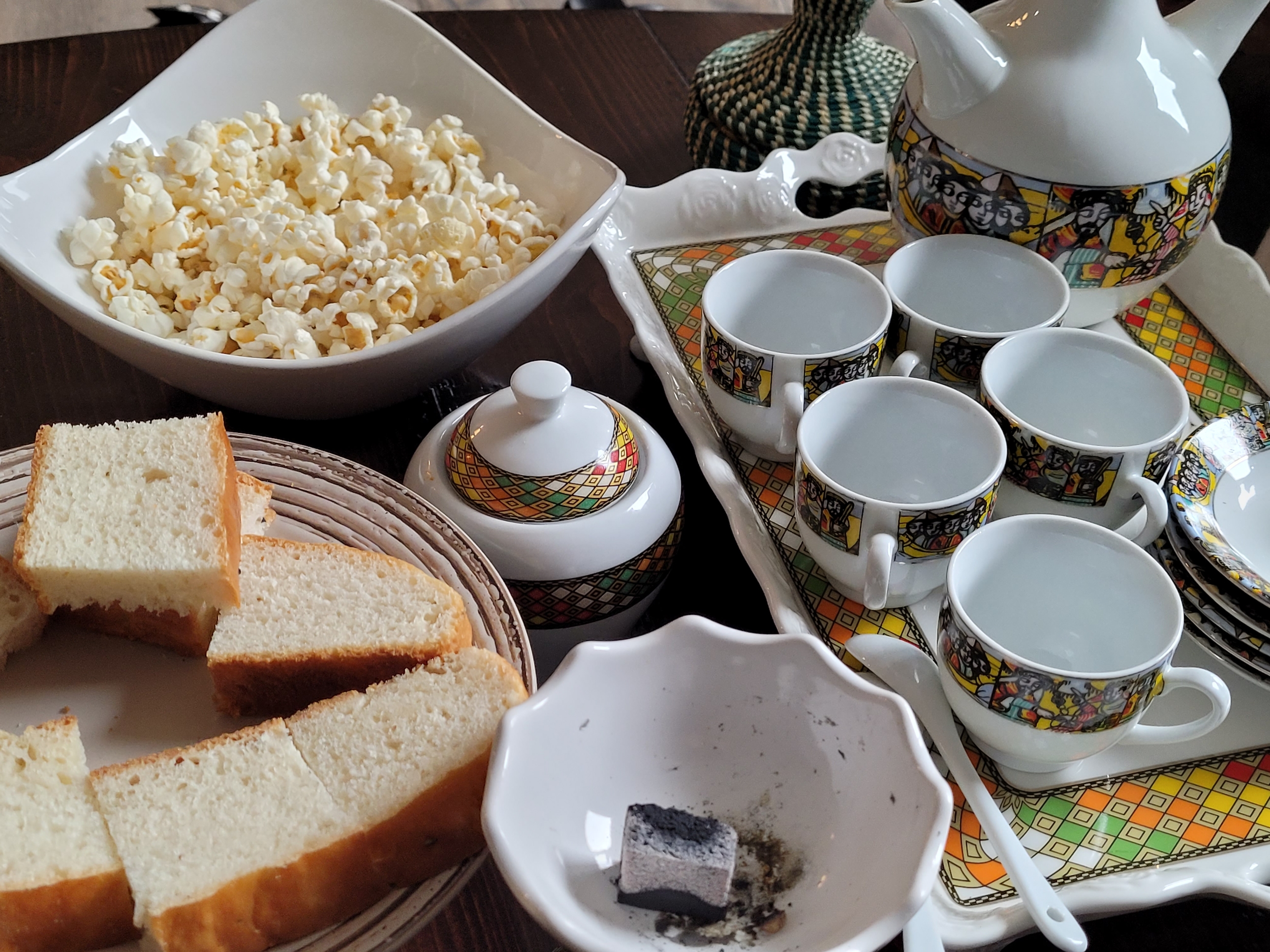 Rekebot coffee table set up with sini cups, incense burner, and snacks ready for guests at a celebration
