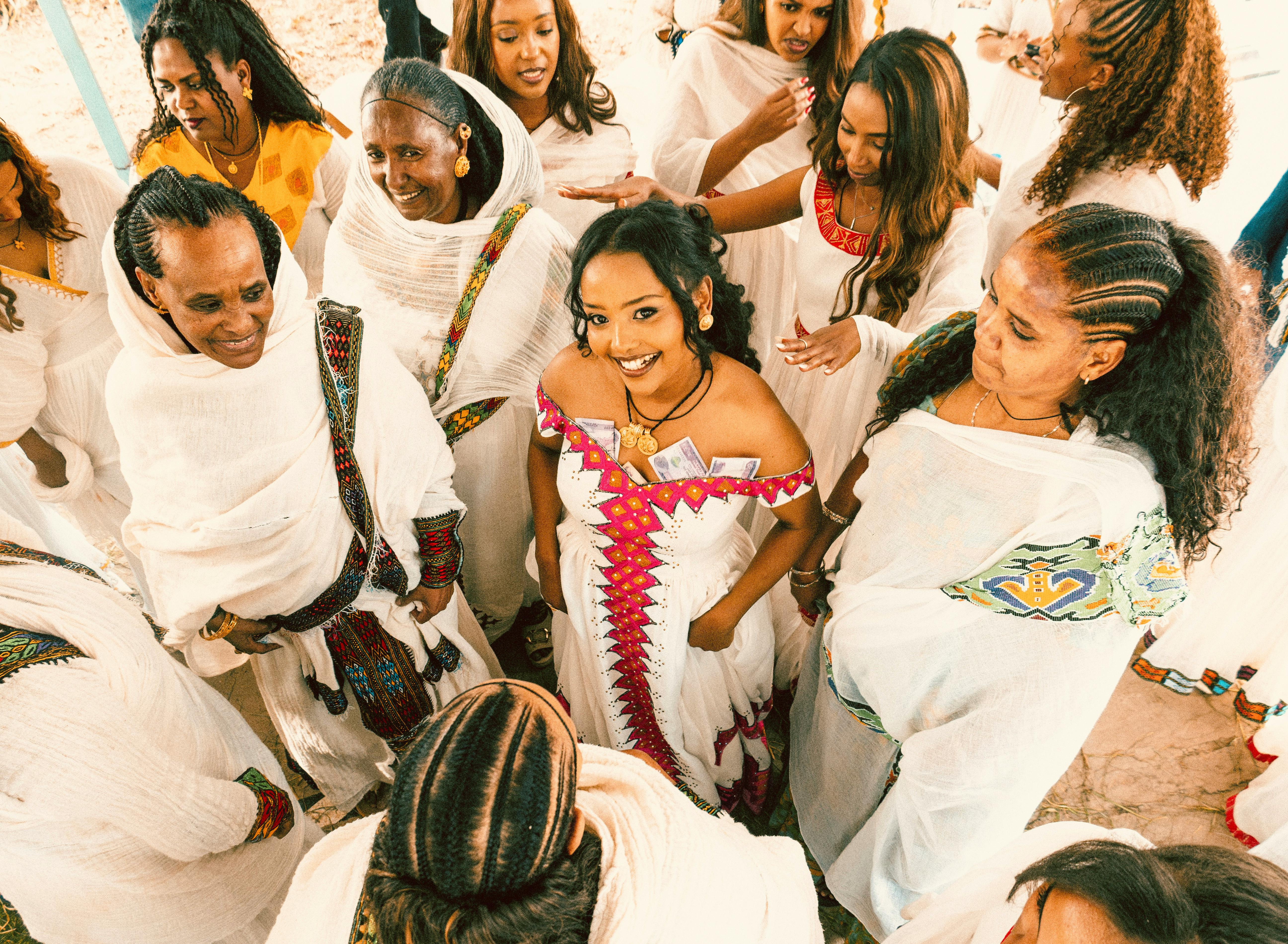 Ethiopian or Eritrean wedding guests performing eskista dance at a melsi celebration