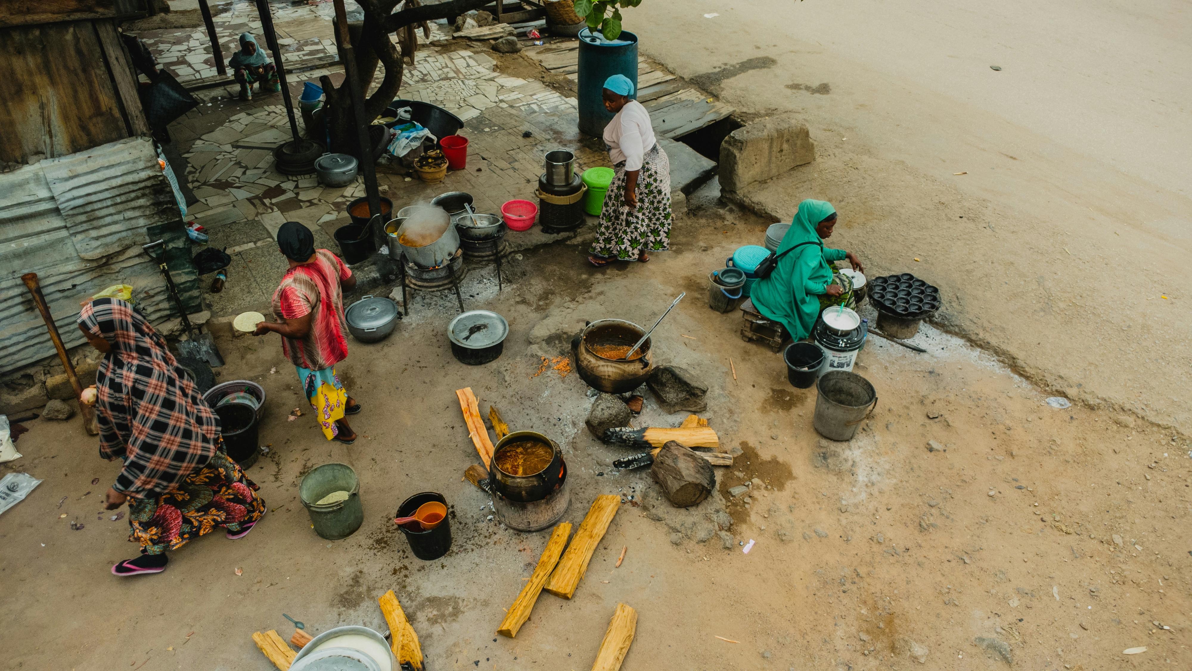 Elegant Nigerian wedding buffet setup with labeled dishes including jollof rice, fried rice, and assorted proteins in chafing dishes
